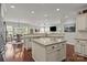 Open kitchen area with island, breakfast area, and view into living room at 16034 Rushwick Dr, Huntersville, NC 28078