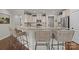 Bright kitchen featuring a granite countertop bar with seating and stainless steel appliances at 16034 Rushwick Dr, Huntersville, NC 28078