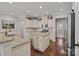 Bright kitchen with island, granite countertops, stainless steel appliances, and hardwood floors at 16034 Rushwick Dr, Huntersville, NC 28078
