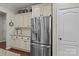 Kitchen featuring stainless steel refrigerator, white cabinets, and granite counters at 16034 Rushwick Dr, Huntersville, NC 28078