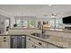 Bright kitchen with granite counters, stainless appliances, and view into the living room at 16034 Rushwick Dr, Huntersville, NC 28078