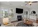 Inviting living room features a cozy fireplace, a TV, and a sliding glass door to a patio at 16034 Rushwick Dr, Huntersville, NC 28078