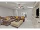 Cozy living space with a comfortable sofa, ceiling fan, and custom built-in shelving at 16034 Rushwick Dr, Huntersville, NC 28078