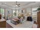 Spacious main bedroom featuring tray ceilings, large windows, bench and bedside tables at 16034 Rushwick Dr, Huntersville, NC 28078