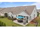 Outdoor patio featuring a dining table and grill, perfect for entertaining at 16034 Rushwick Dr, Huntersville, NC 28078