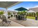 Outdoor patio with dining set, barbecue grill, and a well-manicured lawn at 16034 Rushwick Dr, Huntersville, NC 28078