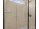 Modern shower stall enclosed with glass door and tiled surround and a shower head at 16034 Rushwick Dr, Huntersville, NC 28078