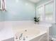 Bright bathroom featuring a soaking tub, neutral tile, and a plant for added serenity at 1626 Riverglenn Ct, Rock Hill, SC 29732