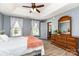 Inviting bedroom featuring wood floors, large windows, and an elegant wood dresser at 1626 Riverglenn Ct, Rock Hill, SC 29732