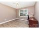 Bedroom with wood floors, natural light, and desk is perfect for work or relaxation at 1626 Riverglenn Ct, Rock Hill, SC 29732