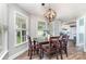 Dining room with a wooden table set and modern chandelier at 1626 Riverglenn Ct, Rock Hill, SC 29732
