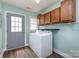 Functional laundry room featuring a washer, dryer, and cabinets for ample storage at 1626 Riverglenn Ct, Rock Hill, SC 29732