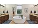 Elegant bathroom featuring a freestanding tub, dual vanities, and stylish nautical themed decor at 164 Twin Sisters Ln, Mooresville, NC 28117