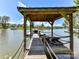 Beautiful wooden dock featuring a boat slip, lounge chairs, and waterfront views of Lake Norman at 164 Twin Sisters Ln, Mooresville, NC 28117
