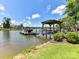 Picturesque waterfront scene featuring a private dock with a covered area, perfect for enjoying lake views at 164 Twin Sisters Ln, Mooresville, NC 28117