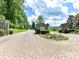 Elegant gated entrance of the Sisters neighborhood featuring stone pillars and landscaping at 164 Twin Sisters Ln, Mooresville, NC 28117