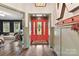 Welcoming entryway with hardwood floors, a red front door, and stylish decor elements at 164 Twin Sisters Ln, Mooresville, NC 28117