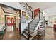 Hallway with staircase, gallery wall art, and dark stained wood flooring at 164 Twin Sisters Ln, Mooresville, NC 28117