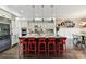 Modern kitchen with stainless steel appliances, white cabinets, and a large granite island at 164 Twin Sisters Ln, Mooresville, NC 28117