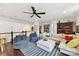 Spacious living room with hardwood floors, ceiling fan, a large sectional sofa, and lots of natural light at 164 Twin Sisters Ln, Mooresville, NC 28117