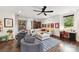 Bright living room with a large sectional sofa, hardwood floors, ceiling fan, and windows that let in lots of natural light at 164 Twin Sisters Ln, Mooresville, NC 28117
