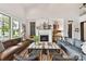 Cozy living room featuring a fireplace, large windows, and comfortable seating arrangement at 164 Twin Sisters Ln, Mooresville, NC 28117