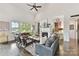 Bright and airy living room featuring a fireplace, hardwood floors, and large windows with waterfront views at 164 Twin Sisters Ln, Mooresville, NC 28117