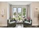 Cozy sitting area with lake view windows, comfortable chairs, and bright natural light at 164 Twin Sisters Ln, Mooresville, NC 28117