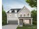Charming two-story home with gray siding, dark roof, and attached two-car garage with a concrete driveway at 1807 Country Club Rd, Lincolnton, NC 28092