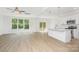 Bright, open-concept living space with wood-look floors and lots of natural light from large windows at 1807 Country Club Rd, Lincolnton, NC 28092