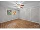 Cozy bedroom featuring hardwood floors, wood paneled walls, and a ceiling fan at 1810 Country Manor Ln # 34, Rock Hill, SC 29730