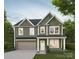 New construction home featuring a two-car garage, neutral color palette, and professionally landscaped front yard at 1811 Country Club Rd, Lincolnton, NC 28092