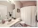 Clean bathroom with modern fixtures, a large mirror, and a shower with a white curtain at 18605 Ruffner Dr # 3E, Cornelius, NC 28031