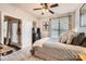 Comfortable bedroom with large window, ceiling fan, and access to a private balcony at 18605 Ruffner Dr # 3E, Cornelius, NC 28031