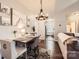 Cozy dining area with modern chandelier, stylish decor, and hardwood floors at 18605 Ruffner Dr # 3E, Cornelius, NC 28031