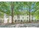 Apartment building with well-maintained landscaping and mature trees providing shade at 18605 Ruffner Dr # 3E, Cornelius, NC 28031