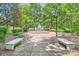 Community fountain area with stone benches, mature trees, and landscaping at 18605 Ruffner Dr # 3E, Cornelius, NC 28031