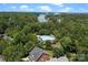 Aerial view of community pool and lake, surrounded by mature trees and lush landscaping at 20324 Middletown Rd, Cornelius, NC 28031