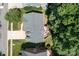 Aerial shot of a home featuring a deck, green lawn, and a long driveway nestled among lush trees at 20324 Middletown Rd, Cornelius, NC 28031