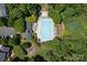 Aerial view of community pool with ample lounge seating, playground, mature trees, and lush landscaping at 20324 Middletown Rd, Cornelius, NC 28031