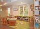 Cozy basement space with rocking chair, carpet, and plenty of natural light at 20324 Middletown Rd, Cornelius, NC 28031