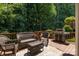 Outdoor living space featuring deck with wicker furniture, outdoor rug, grill, and wooded views at 20324 Middletown Rd, Cornelius, NC 28031