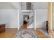 Bright and airy foyer featuring hardwood floors, a staircase, and views into adjacent living spaces at 20324 Middletown Rd, Cornelius, NC 28031