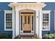 Charming front door with decorative glass and white trim flanked by windows and brick accents at 20324 Middletown Rd, Cornelius, NC 28031