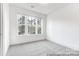 Neutral bedroom featuring a large window, carpet flooring, and recessed lighting at 236 Wheatfield Dr # 102P, Statesville, NC 28677