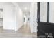 Bright entryway featuring light wood floors and white wainscoting, leading to an open-concept living space at 236 Wheatfield Dr # 102P, Statesville, NC 28677