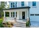 Charming front porch with brick accents, white columns, and a cozy seating area at 236 Wheatfield Dr # 102P, Statesville, NC 28677