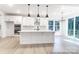Open-concept kitchen with stainless steel appliances, white cabinetry, and a large island at 236 Wheatfield Dr # 102P, Statesville, NC 28677