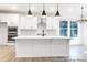 Modern kitchen with white cabinets, stainless steel appliances, a spacious island, and stylish pendant lighting at 236 Wheatfield Dr # 102P, Statesville, NC 28677