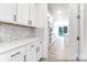 Stylish kitchen with mosaic backsplash, sleek appliances, and white cabinets, offering a modern culinary space at 236 Wheatfield Dr # 102P, Statesville, NC 28677